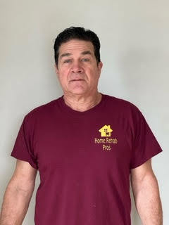 Geoff in his employee t-shirt that is maroon and yellow. 