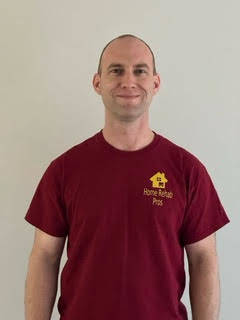 Jason in his employee t-shirt that is maroon and yellow. 